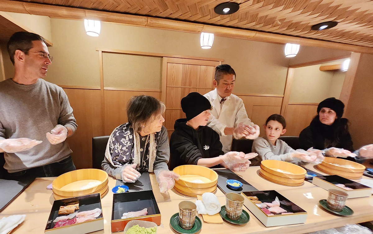 A family participating in a sushi masterclass at Oikawa, a Japanese restaurant