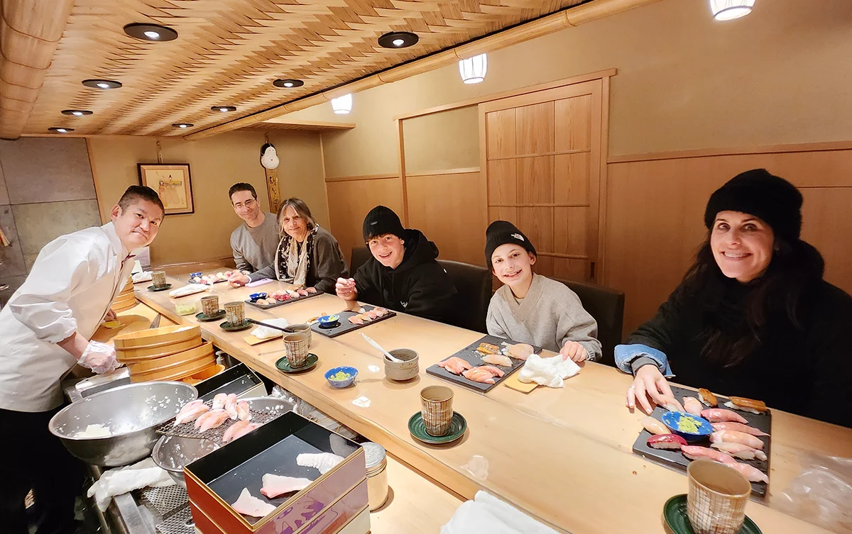 A family enjoying the experience of making their own sushi